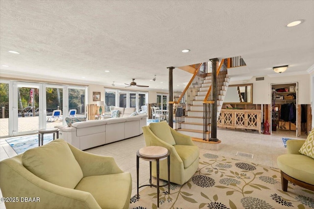 tiled living room featuring french doors, ornamental molding, and a textured ceiling