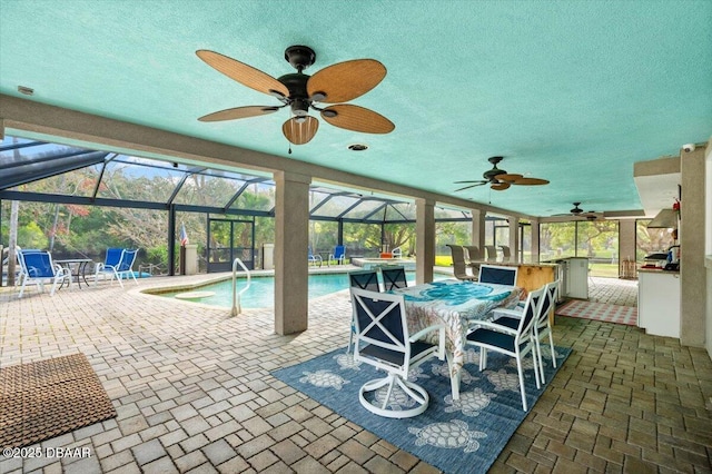 view of swimming pool with ceiling fan, exterior bar, a patio area, and a hot tub