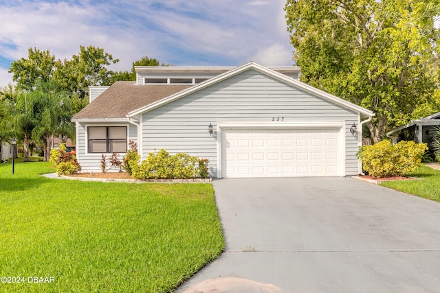 front of property with a garage and a front lawn