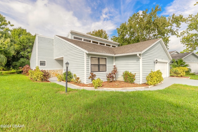 view of front of property featuring a front yard and a garage