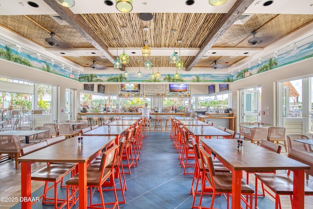 dining space featuring a towering ceiling, visible vents, coffered ceiling, and beam ceiling