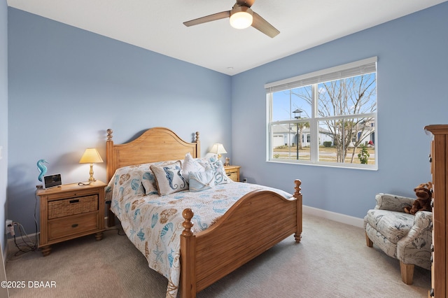 bedroom with a ceiling fan, baseboards, and carpet flooring