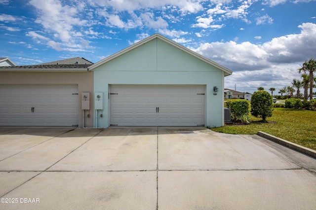 garage with driveway and cooling unit