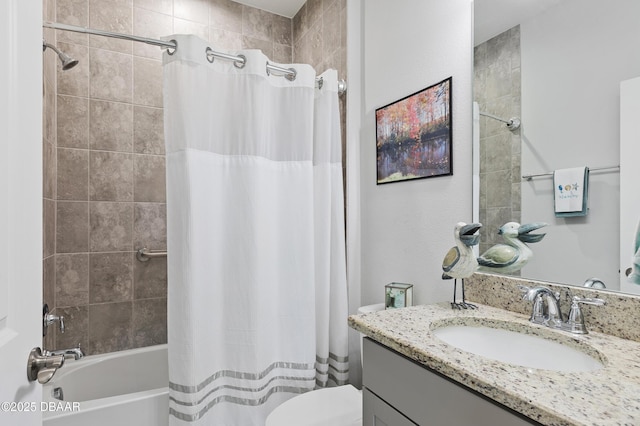 full bath with shower / bath combo, vanity, and toilet