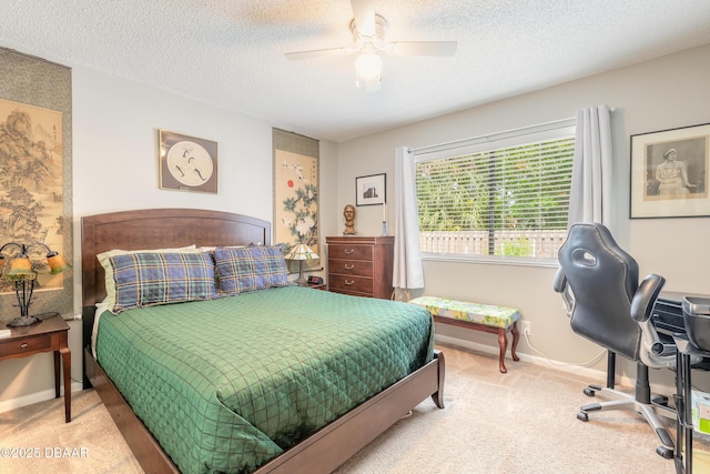 carpeted bedroom featuring ceiling fan and a textured ceiling