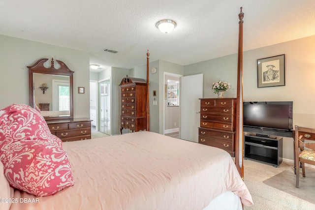 bedroom featuring light carpet and a textured ceiling