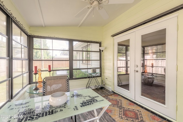 sunroom / solarium with ceiling fan, lofted ceiling, and french doors