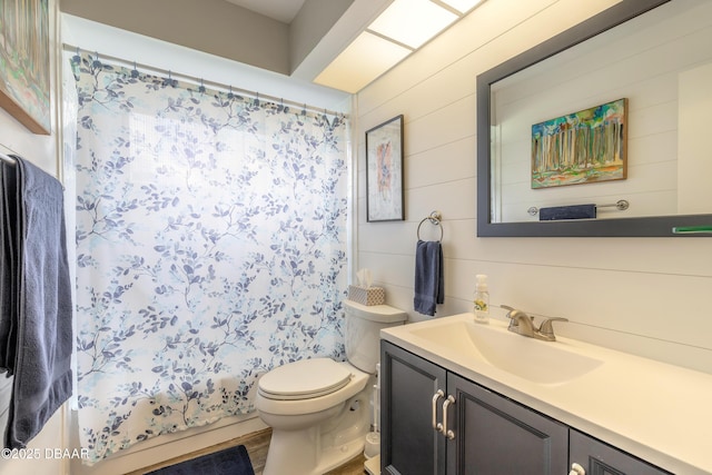 full bathroom with toilet, vanity, wooden walls, and shower / bath combo with shower curtain