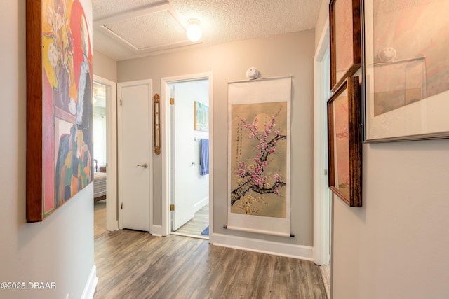 corridor featuring a textured ceiling and dark wood-type flooring