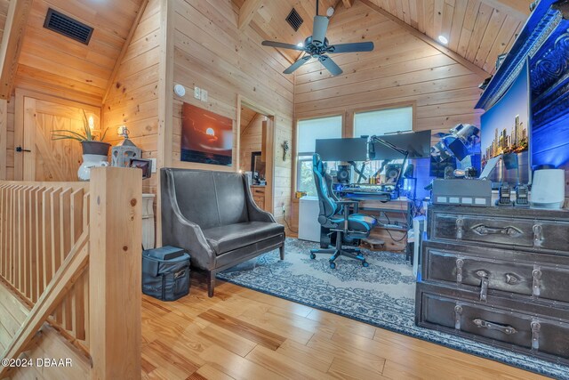 office with hardwood / wood-style floors, wooden walls, wood ceiling, and high vaulted ceiling