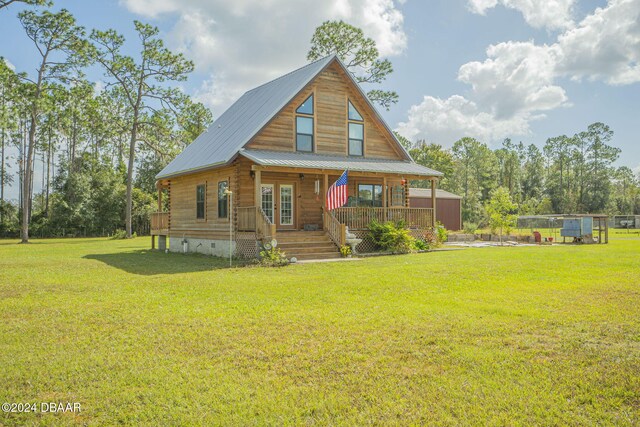 view of front of house with covered porch and a front yard