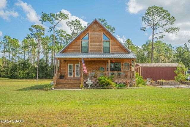 back of house featuring a lawn and a porch