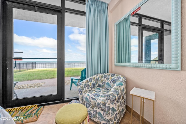 2301 S Atlantic Ave Unit 132, Daytona Beach, FL 32118 - living area featuring a textured wall, a water view, and tile patterned flooring