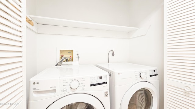 clothes washing area featuring washer and dryer