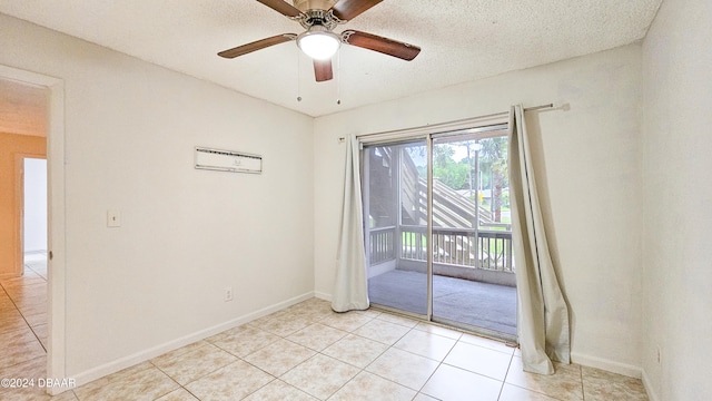 tiled spare room featuring a textured ceiling and ceiling fan