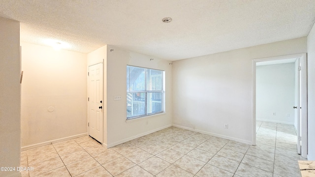 tiled entrance foyer featuring a textured ceiling