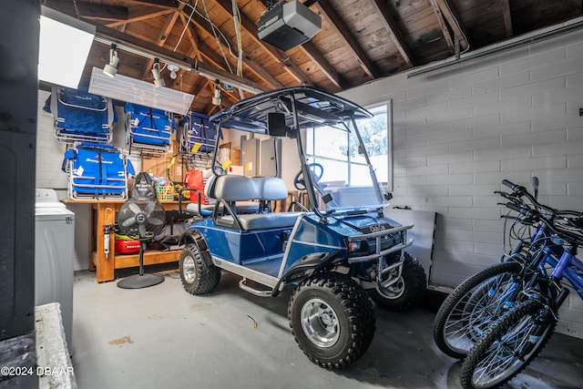 garage featuring wooden ceiling and a garage door opener