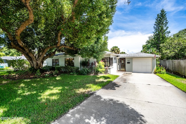 view of front of home with a garage and a front yard