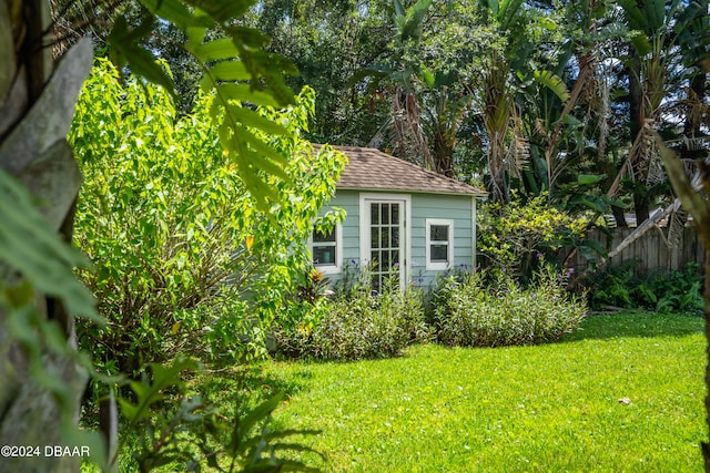 view of outdoor structure featuring a lawn