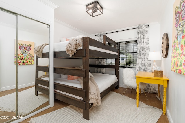 bedroom with wood-type flooring and crown molding