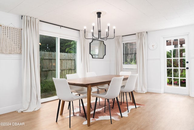 dining area with an inviting chandelier and light wood-type flooring