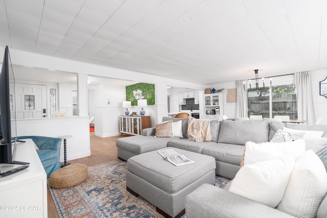 living room featuring hardwood / wood-style floors and a notable chandelier