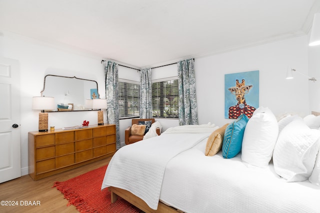 bedroom featuring hardwood / wood-style flooring and ornamental molding