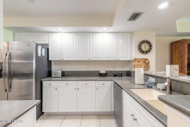 kitchen with white cabinetry, light tile patterned floors, sink, and appliances with stainless steel finishes