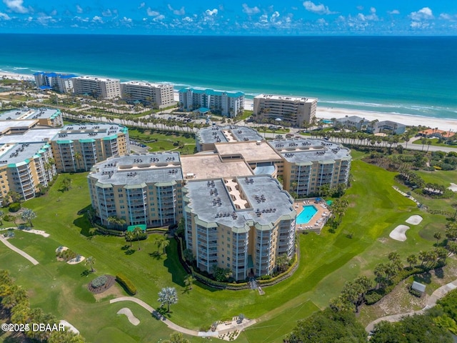 drone / aerial view featuring a water view and a view of the beach