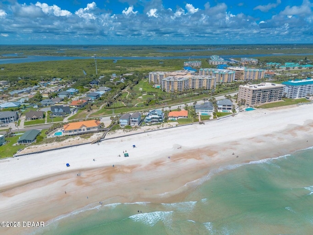 aerial view with a water view and a view of the beach