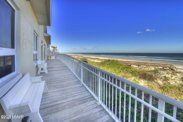 balcony with a water view and a beach view