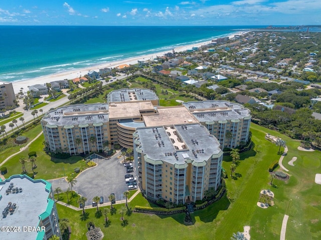 drone / aerial view featuring a beach view and a water view