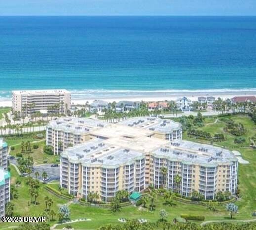 aerial view featuring a water view and a beach view