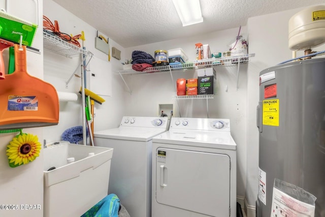 washroom featuring water heater, washing machine and dryer, sink, and a textured ceiling