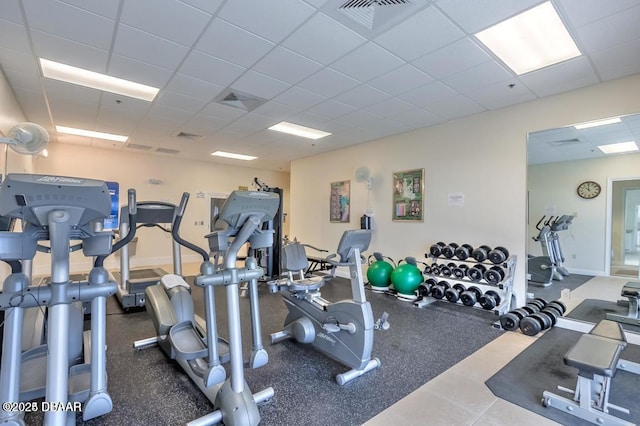 gym with a paneled ceiling