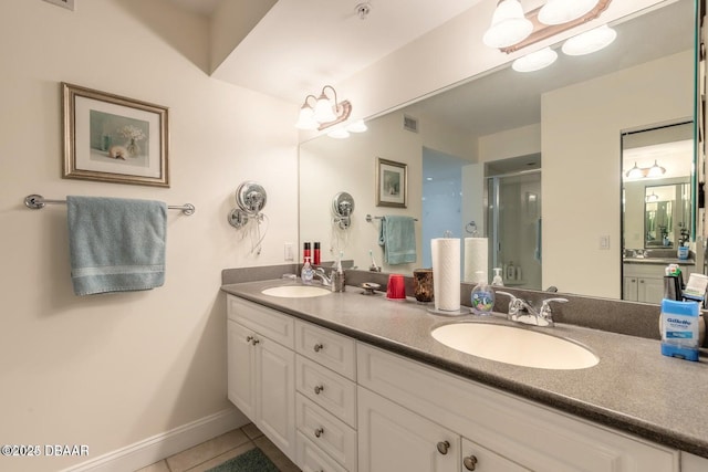 bathroom featuring vanity, tile patterned floors, and a shower with shower door