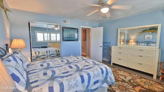 bedroom with a closet, ceiling fan, and dark hardwood / wood-style floors