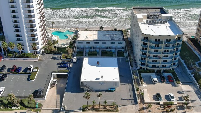 drone / aerial view featuring a beach view and a water view