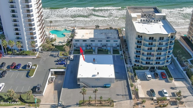 bird's eye view with a water view and a beach view