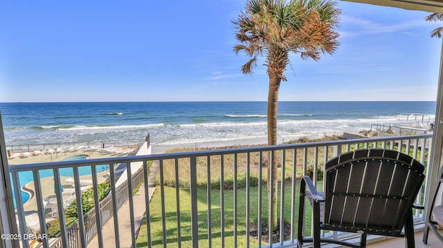 balcony with a view of the beach and a water view