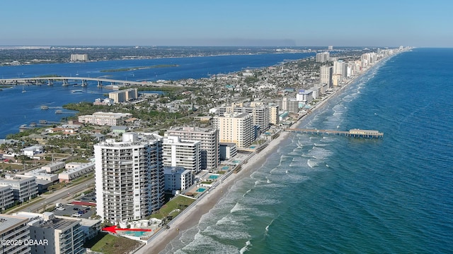 birds eye view of property featuring a water view and a beach view