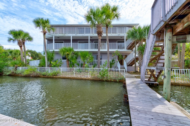 dock area featuring a water view and a balcony