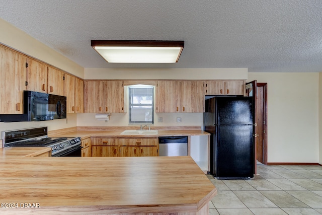 kitchen featuring butcher block countertops, a textured ceiling, sink, and black appliances