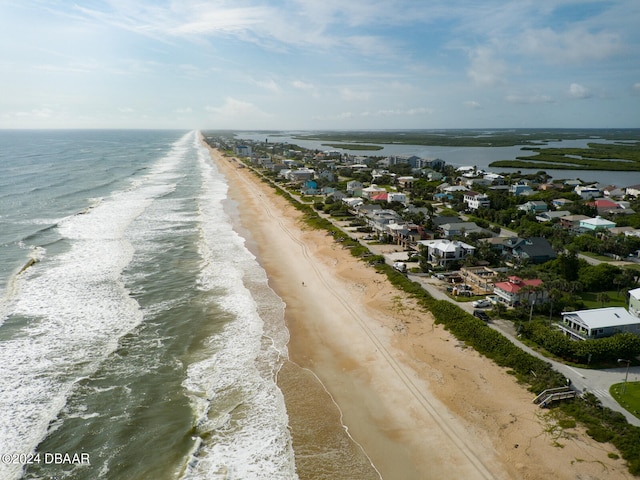 aerial view with a water view and a beach view