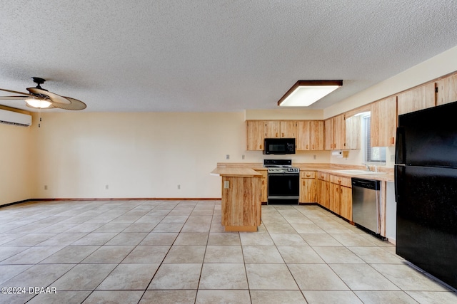 kitchen featuring a wall unit AC, a textured ceiling, light brown cabinetry, and black appliances