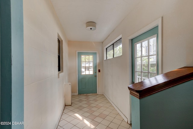 doorway with light tile patterned floors