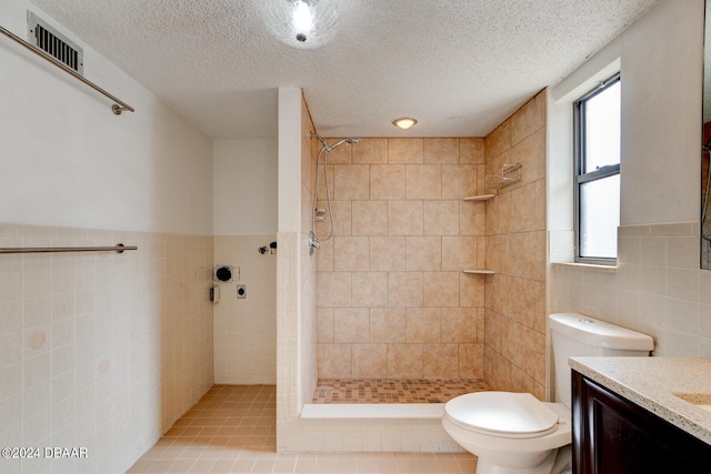 bathroom featuring vanity, curtained shower, and tile walls