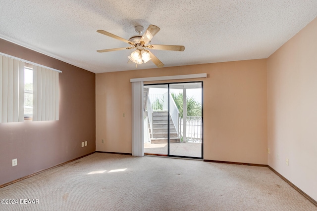 carpeted empty room with a textured ceiling and ceiling fan