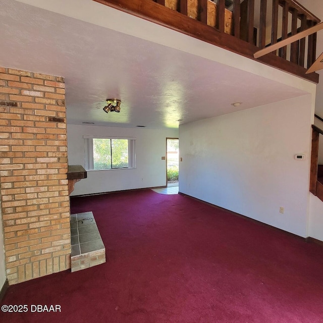 unfurnished living room featuring carpet floors