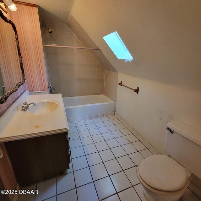 full bath featuring vanity, shower / bathtub combination, lofted ceiling with skylight, toilet, and tile patterned floors